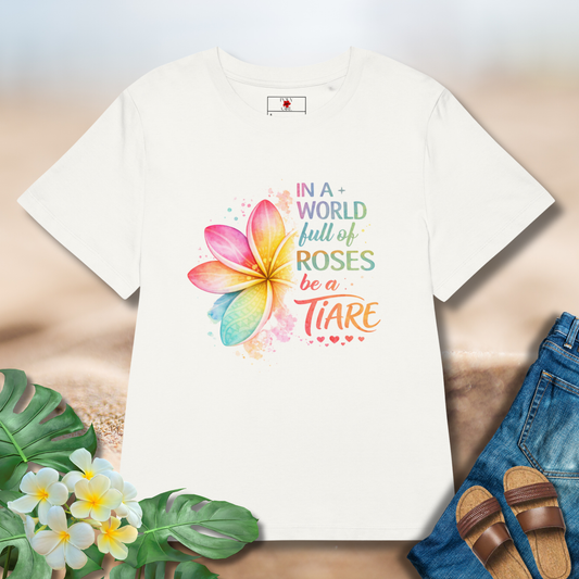 White tshirt with pua flower and the words In a world full of roses, be a Tiare.