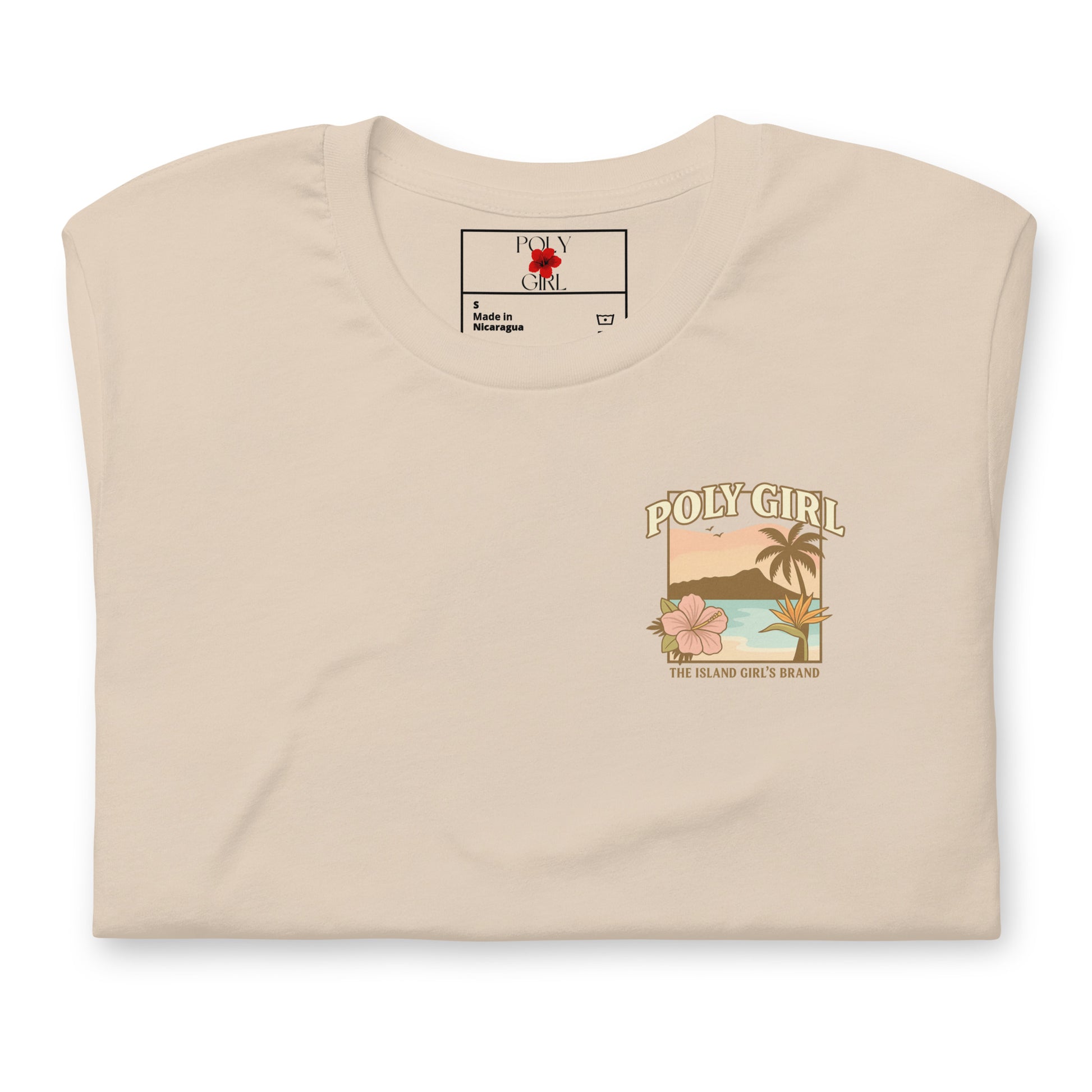 Folded Poly Girl t-shirt showing tropical sunset and flower design on front chest.