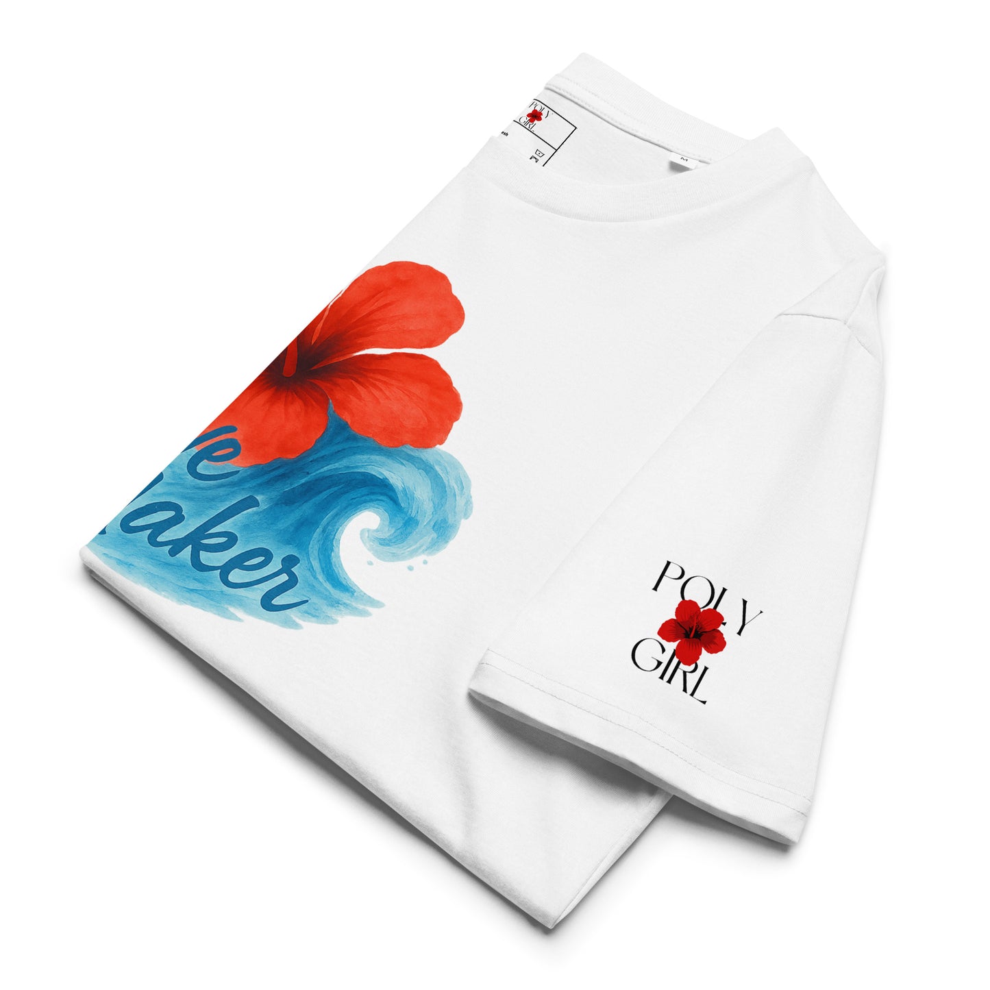 Close-up of Poly Girl Wave Maker tee, folded, showing Poly Girl logo on left sleeve and vibrant hibiscus and flowing wave artwork